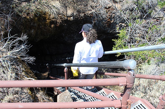 A visitor descends into one of the two dozen lava tubes or caves found at Lava Beds National Monument.