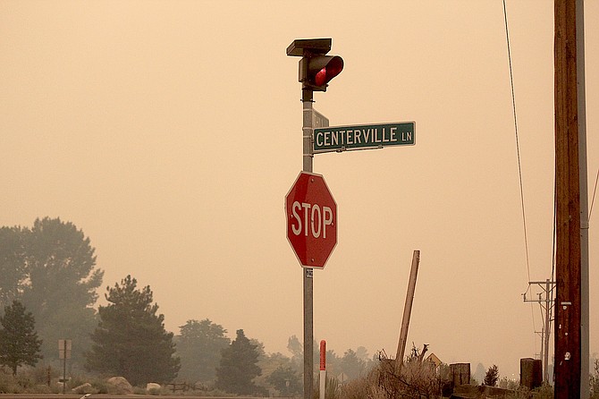 Smoke was thick along Foothill Road on Tuesday evening as Douglas County Sheriff's Search and Rescue team members started notifying residents its possible they may have to evacuate.