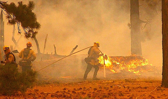 Firefighters work along Highway 89 in California on the Caldor Fire. Photo by Bill Rozak/Tahoe Daily Tribune