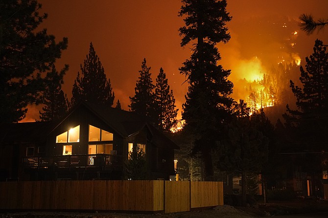 The Caldor Fire burns near homes near South Lake Tahoe on Wednesday, Sept. 1, 2021. (AP Photo/Jae C. Hong)