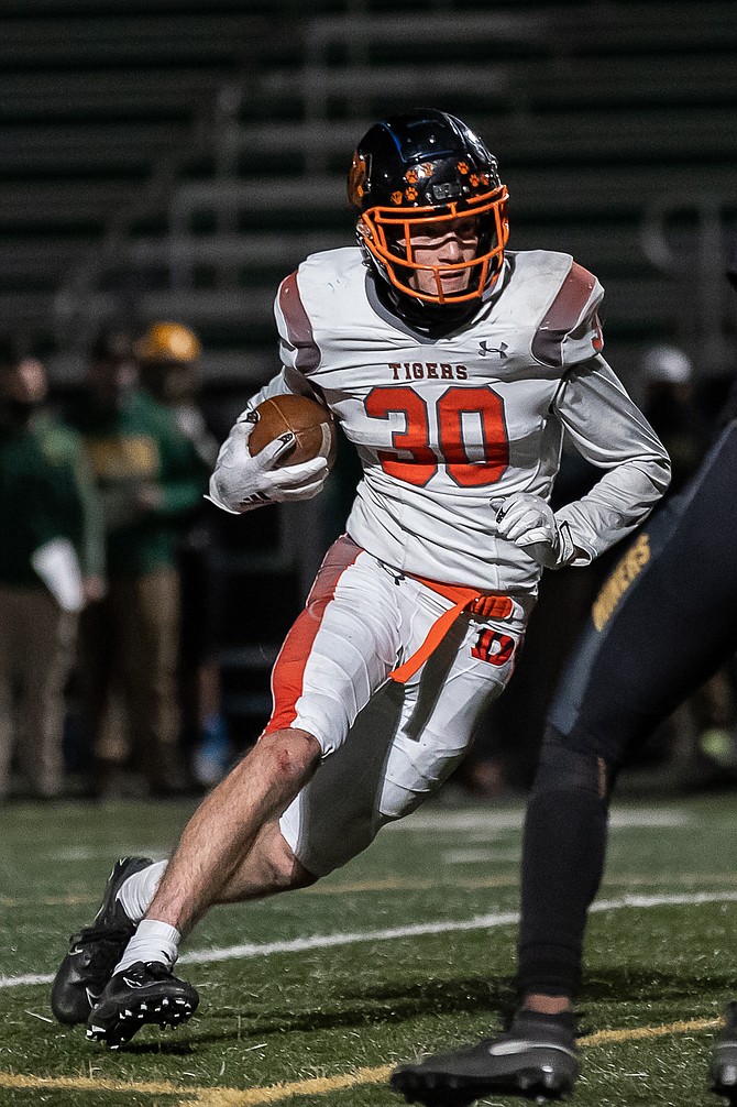 Douglas High’s Chris Smalley turns the corner during the 2021 spring season. The Tiger football team is hoping it will get a chance to play its home opener Friday against McQueen.