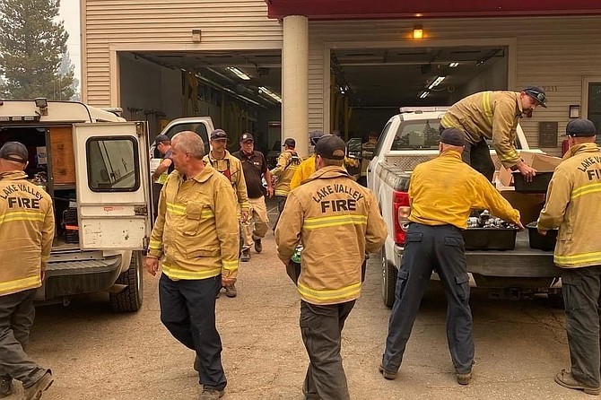 Lake Valley firefighters unload supplies brought to them by their spouses after they outstripped their supplies. Photo uploaded to Gofundme by Sara Pierce