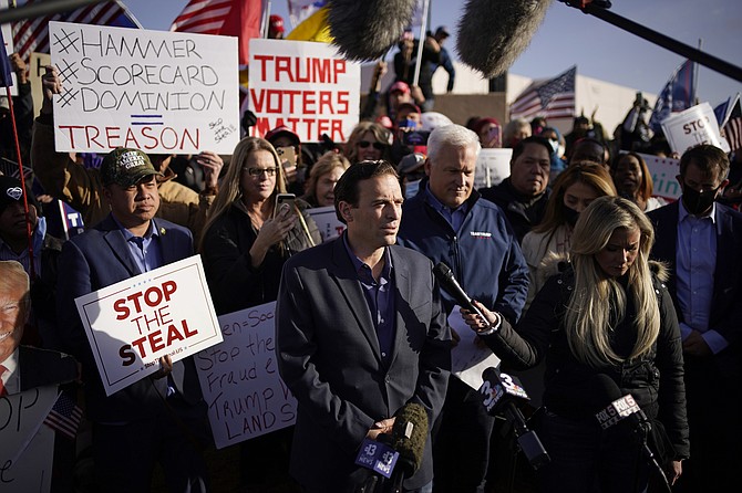 John Locher/AP, file
Former Nevada Attorney General Adam Laxalt, middle speaking at microphone, and American Conservation Union Chairman Matt Schlapp speak during a news conference outside of the Clark County Election Department in North Las Vegas on Nov. 8, 2020.