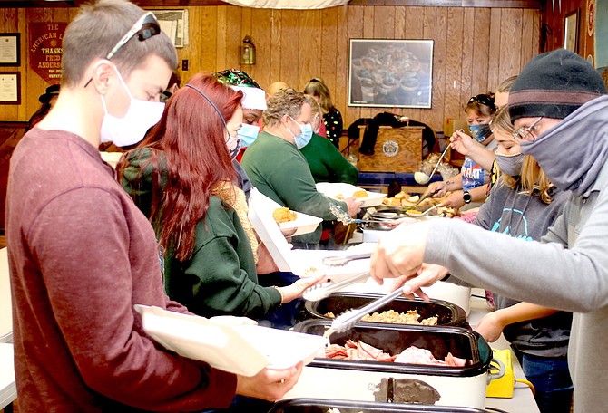 American Legion members and volunteers prepare and package meals for the area’s senior citizens on Thanksgiving Day 2020.