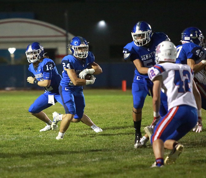 Carson High running back Wes Dunkin (24) takes a carry up the middle while playing at Reno High Friday night.