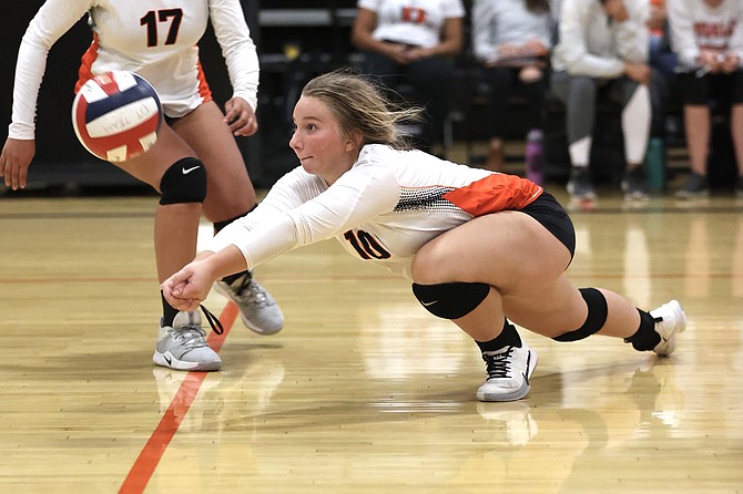 Douglas High’s Emma Glover makes a dig against Galena on Tuesday in the Tigers’ home gym. The Grizzlies beat Douglas for an early-season win.