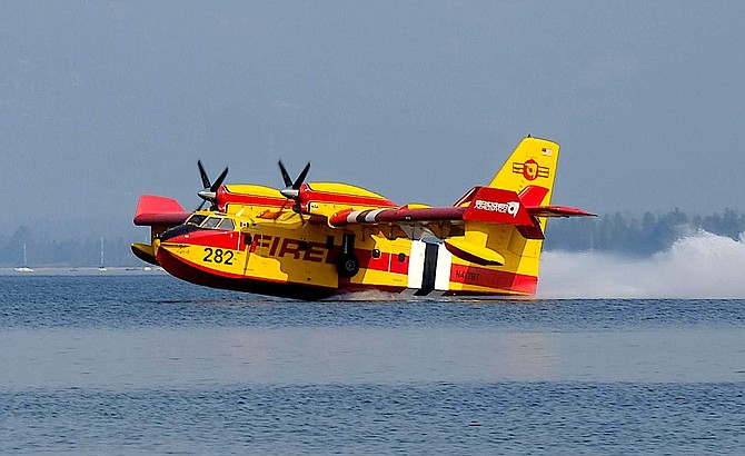 A scooper plane picks up water from Lake Tahoe to fight the Caldor Fire. U.S. Forest Service photo
