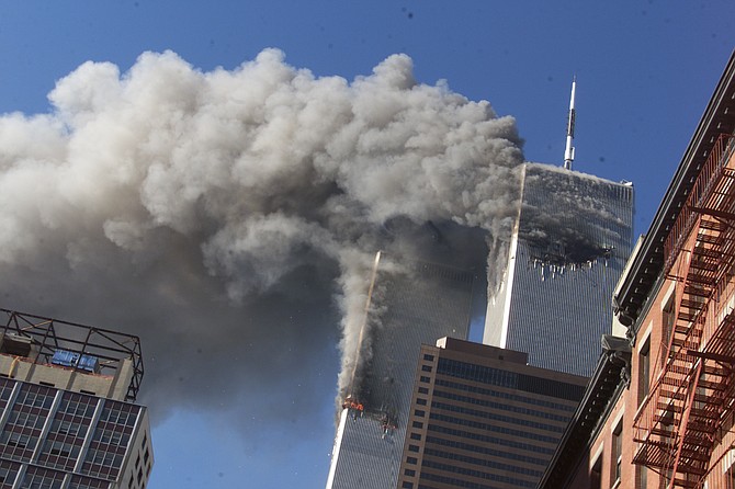 Smoke rises from the burning twin towers of the World Trade Center on Sept. 11, 2001 in New York City. (AP Photo/Richard Drew)