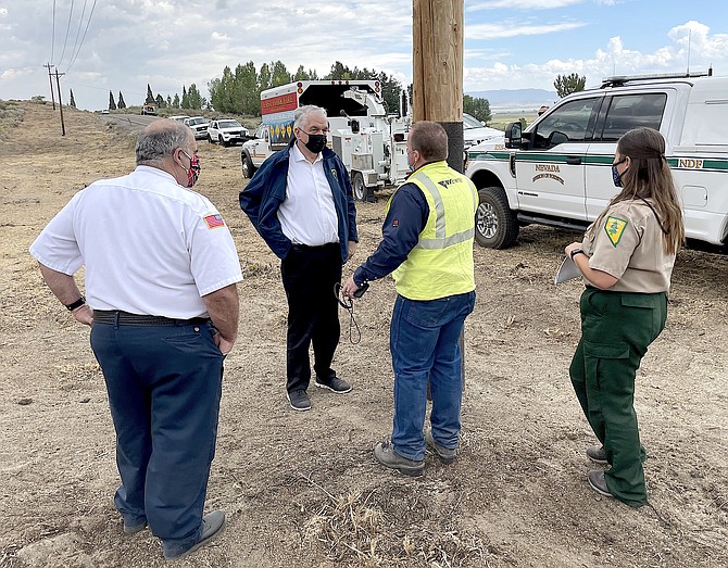 Gov. Steve Sisolak tours power lines along Foothill Road on Friday that were cleared of brush by an East Fork hand crew funded by NV Energy to prevent equipment from causing fires and help stop fires from damaging equipment.