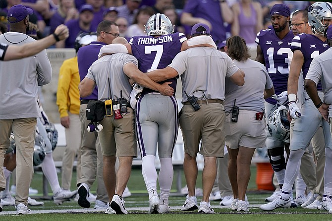 Kansas State quarterback Skylar Thompson is helped off the field after being injured Sept. 11, 2021 against Southern Illinois in Manhattan, Kan. (AP Photo/Charlie Riedel)
