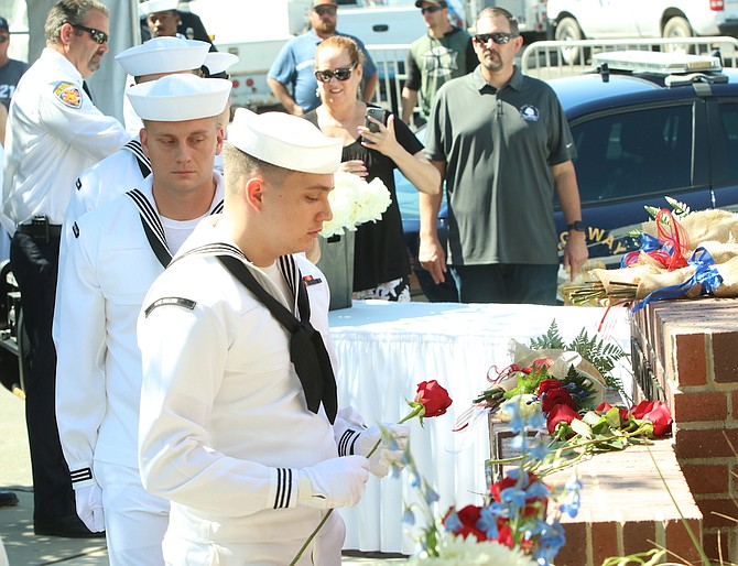 Sailors from Naval Air Station Fallon place roses at the city’s 9/11 Memorial.