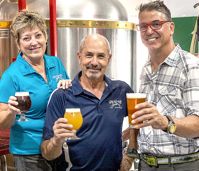Great Basin Brewing Co. founders, Bonday and Tom Young, toasting Local Food Group Chief Executive Officer Mark Estee. Local Food Group Photo