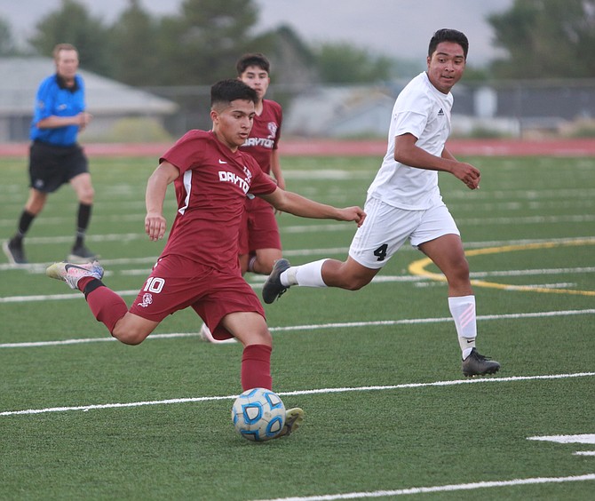 Dayton High senior Juan Aguinaga winds up to shoot against Douglas High School Thursday night. Aguinaga scored once in the Dust Devils’ loss to the Tigers.