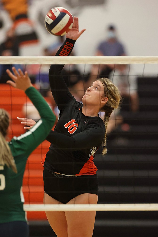 Douglas High’s Riley Mello rises up to play a ball against Damonte Ranch on Tuesday. The Tigers swept the Mustangs in straight sets.