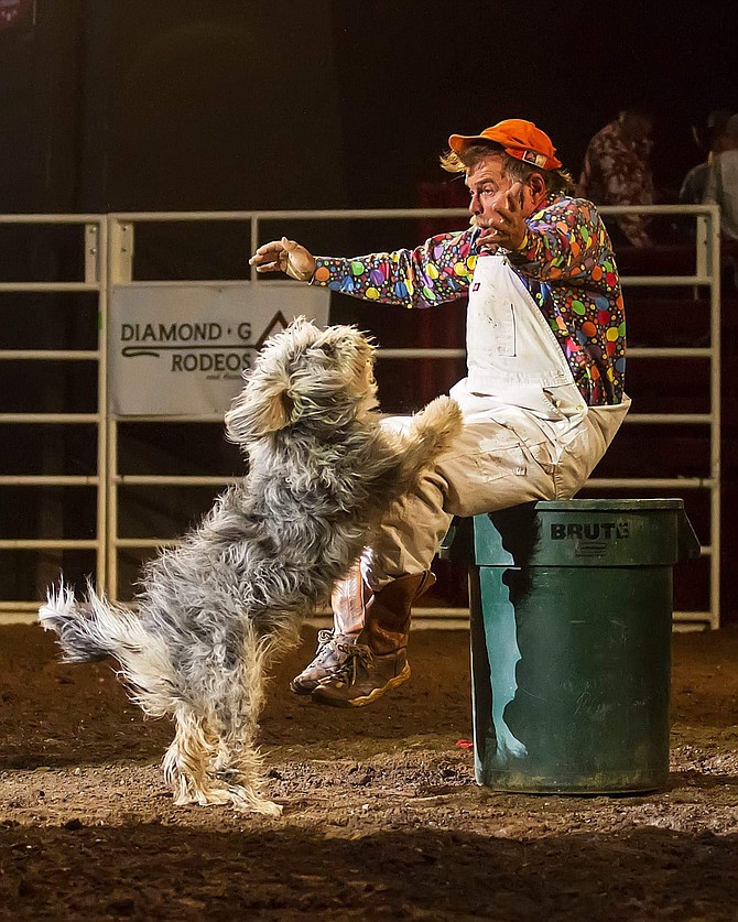 Coppertown Clown Bert Davis performs with one of his dogs. Photo by Andrea Kaus
