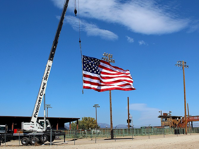 The wind picks up the big flag flying for the Douglas County Rodeo at the Douglas County Fairgrounds on Saturday morning.