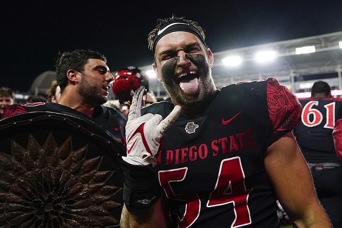 San Diego State linebacker Caden McDonald celebrates after a 33-31 win in triple overtime against Utah on Sept. 18, 2021, in Carson, Calif. (AP Photo/Ashley Landis)
