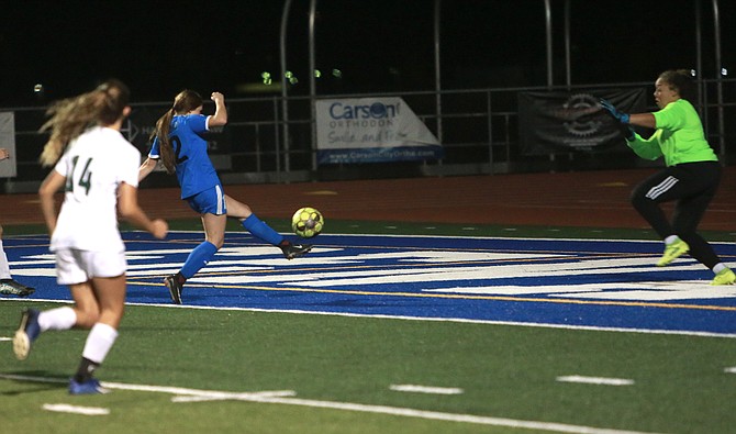Carson High forward Angie Cortes (12) volleys home her goal in the Senators' 2-0 win over Bishop Manogue Tuesday night.