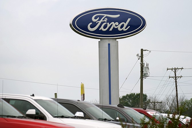 A Ford logo is seen on signage at Country Ford in Graham, N.C., on July 27, 2021. Ford Motor Co. is investing $50 million in an upstart electric vehicle battery recycling company as the automaker moves to bolster its U.S. battery supply chain. (AP Photo/Gerry Broome)