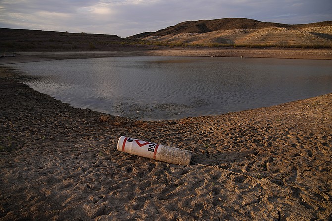 A buoy rests on the ground at a closed boat ramp on Lake Mead at the Lake Mead National Recreation Area near Boulder City on Aug. 13, 2021. (AP Photo/John Locher, File)