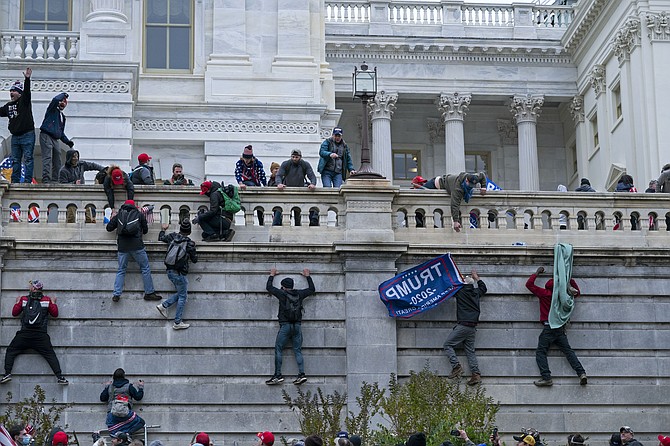 Rioters climb the west wall of the U.S. Capitol in Washington on Jan. 6, 2021. (AP Photo/Jose Luis Magana, File)