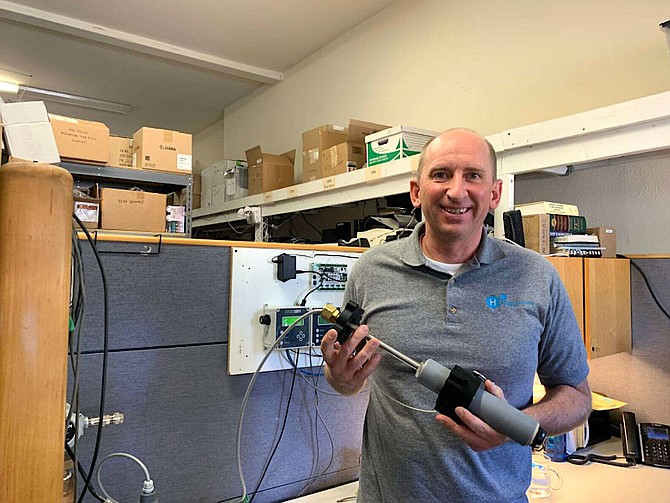 Halogen Systems Sales Executive Michael Travis Silveri holds one of the municipal water sensors that can go directly into pipes; the company says the sensors will eventually result in saving millions of gallons of water per year.
