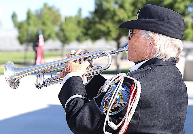 Mary Sedgwick from the Nevada Veterans Coalition plays Taps.