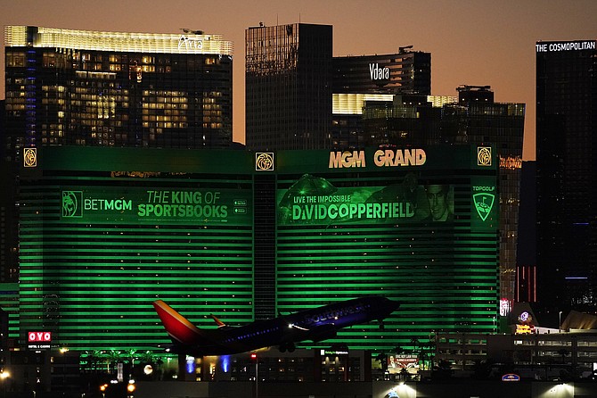 A plane takes off from McCarran International Airport near casinos along the Las Vegas Strip on Sept. 29, 2021, in Las Vegas. (AP Photo/John Locher)