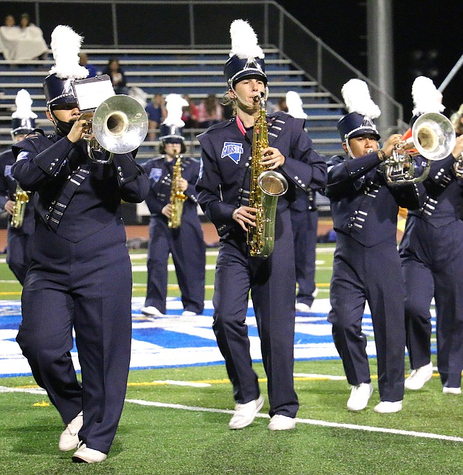 Carson High School Blue Thunder members Pablo Salgado, left, Brett Barbarigos and Alexis Garcia Perez perform at the school’s homecoming game on Sept. 24 against McQueen High School. The band is preselling tickets for its Chili Bingo Night fundraiser on Oct. 15. (Photo: Jessica Garcia/Nevada Appeal)