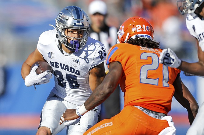 Nevada running back Avery Morrow faces Boise State safety Tyreque Jones on Oct. 2, 2021, in Boise, Idaho. Nevada won 41-31. (AP Photo/Steve Conner)
