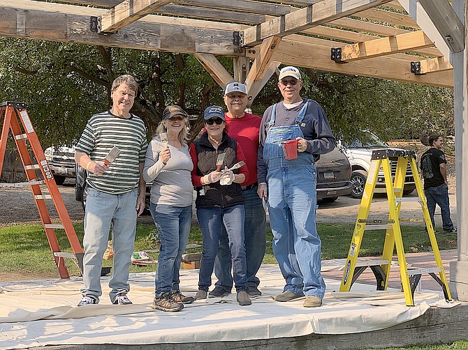 Friends of Genoa (through generous donations),  Minden Rotary Club, and Genoa Co. have collaborated to refurbish the Genoa Bandstand. Here members of the Rotary Club take a break for a photo while staining the bandstand the week before Candy Dance.