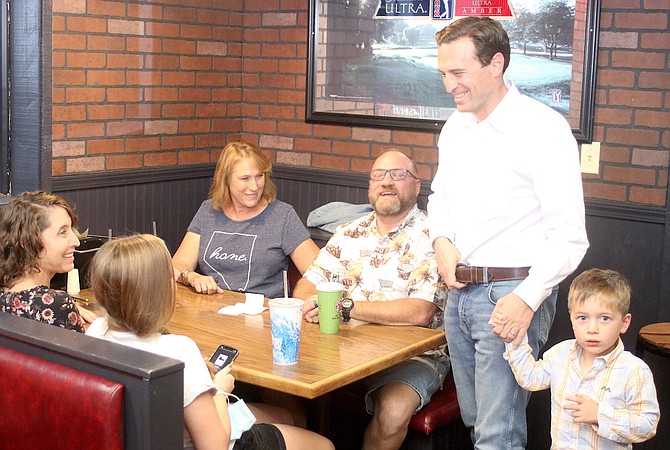 Former Attorney General Adam Laxalt, who is running for U.S. Senate, meets people at a Fallon event Sunday night.