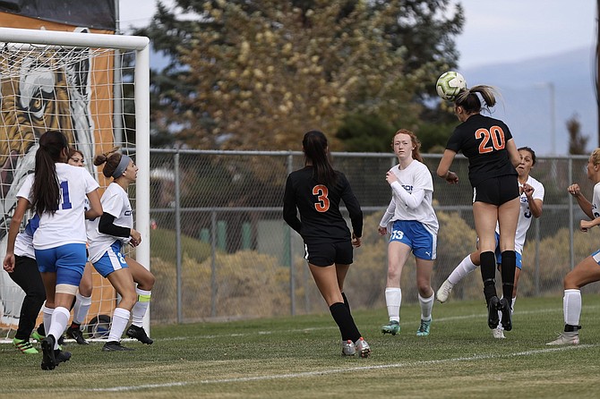 Aleeah Weaver (20) puts her head to a goal in the second minute of Douglas' 2-1 win over Carson Wednesday.