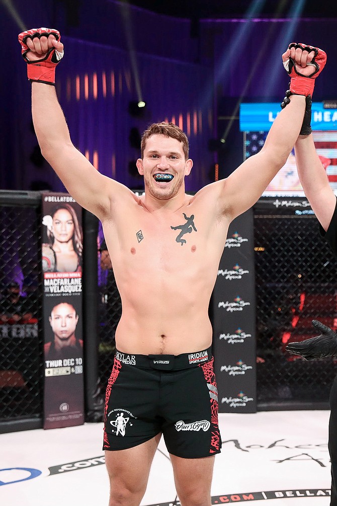 Douglas County native Sullivan Cauley raises his hands in victory after earning a knockout win at Bellator 253 in less than 30 seconds.