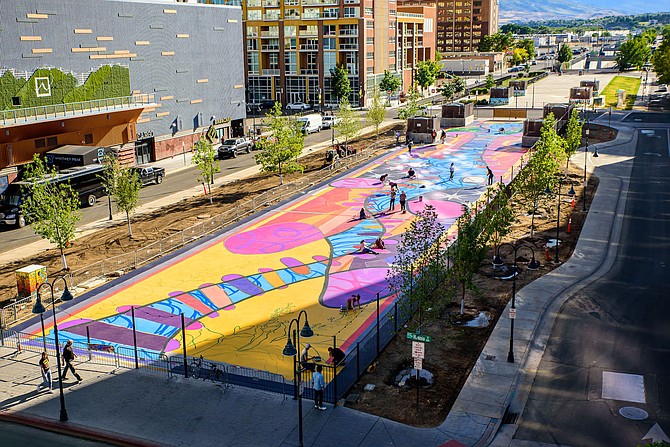 In June 2021, the once-dreary Reno Transportation Rail Access Corridor (ReTRAC) in Downtown Reno was transformed into a vibrant ground mural named “Locomotion,” depicting abstracted Reno-themed images and symbols, such as train tracks, mountains, sagebrush and the city flag.