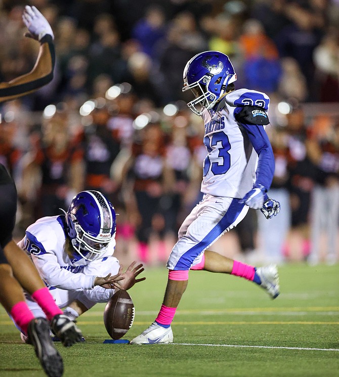 Carson High kicker Isaac Avina swings through his game-winning 20-yard field goal Friday night against Douglas.