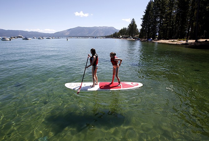 Freya Mayo, left, and her sister Evie, of London, try a paddle board near South Lake Tahoe, Calif., on Aug. 21, 2019. (Photo: Rich Pedroncelli/AP, file)