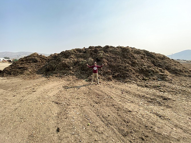 Cody Witt, Northern Nevada Manager at Full Circle Soils and Compost, stands in front of a giant pile of compost at the company’s site in Carson City.