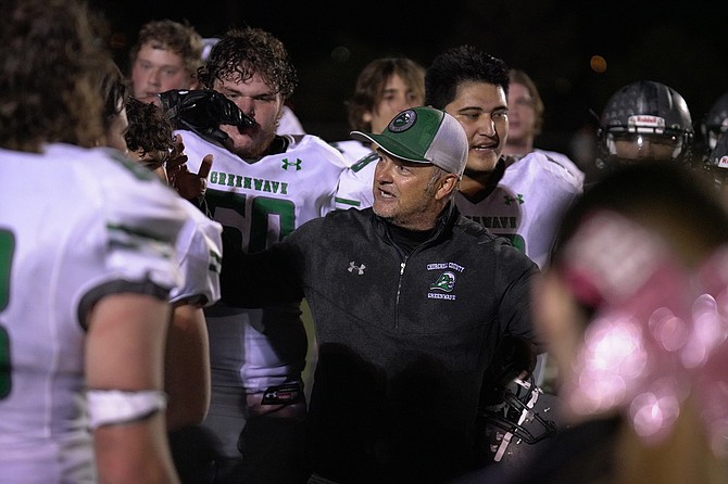 Fallon football coach Brooke Hill talks with his team after beating Fernley on Friday night.