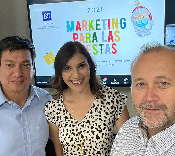 Business instructors Juan Salas, Reyna Mendez and Mike Bindrup stop to take a group selfie at their latest Latin Chamber event, “Marketing para las fiestas.”