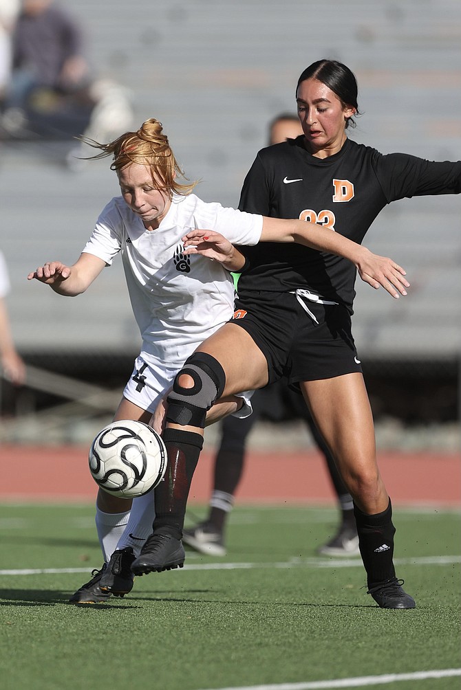 Hannah Schaeffer (23) battles for possession with a Galena forward Monday afternoon at Douglas High School.