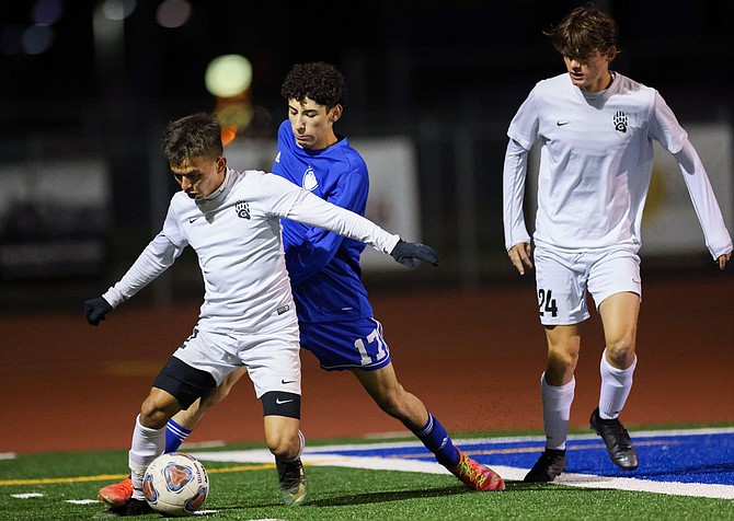 Emiliano bravo (17) attempts to get the ball back from a Galena defender Wednesday night at Carson High.