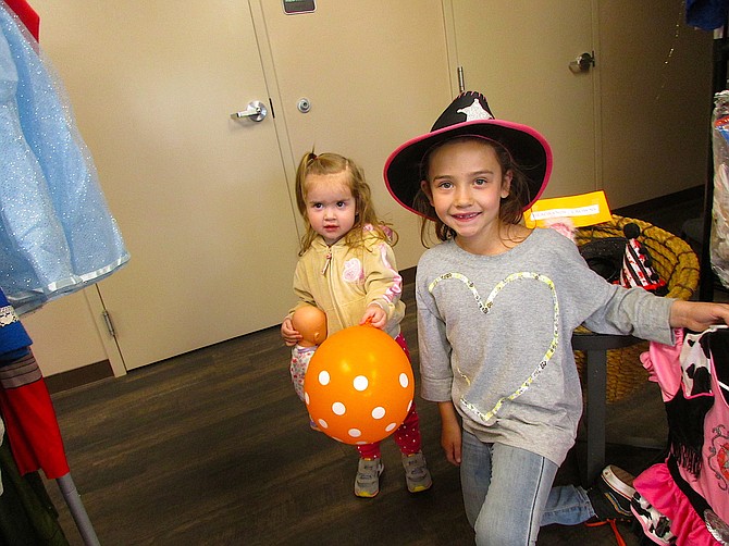 Two-year-old Selena and 7-year-old Madison found outfits during the Family Support Council’s Costume Patch last week.