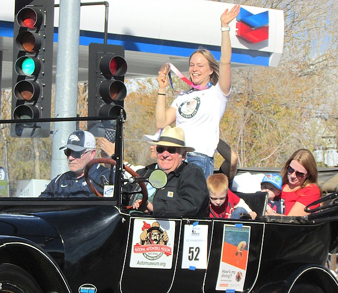 Krysta Palmer waves to the crowd and displays her Bronze medal for diving at Saturday's Nevada Day Parade.
