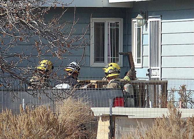 Firefighters overhaul a porch fire on Kayne Drive around lunchtime on Thursday.