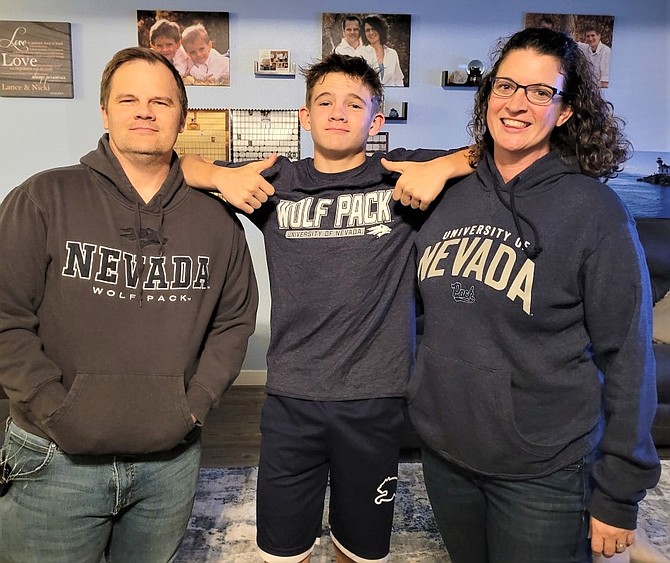 CHS teachers Lance and Nicki Hendee, along with one of their four sons, Ethan, sporting their undergraduate college gear and future college gear during the
