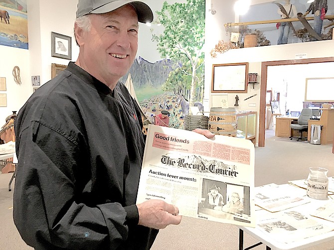 Roger Falck holds up a Dec. 8, 1977, edition of The Record-Courier featuring Harry and Dorothy Atchison, who served as Genoa postmistress. Falcke donated many of the papers on display at the Carson Valley Museum & Cultural Center's first Family Day on Saturday.