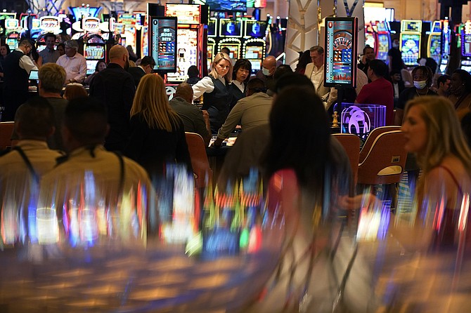 People crowd the casino during the opening night of the Resorts World Las Vegas hotel-casino in Las Vegas on June 24, 2021. (AP Photo/John Locher, File)