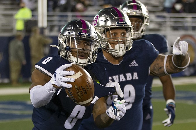 Nevada defensive back Berdale Robins (0) celebrates with teammates after recovering a fumble and returning it for a touchdown against New Mexico State on Oct. 9, 2021 in Reno. (AP Photo/Tom R. Smedes)