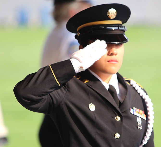 Sgt. Christina Aguilar of the Nevada Army National Guard presents a U.S. flag at a military funeral service at the Northern Nevada Veterans Memorial Cemetery.